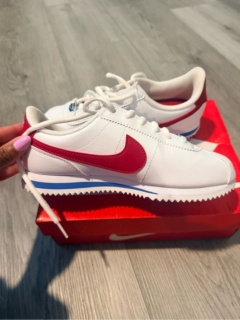 Nike White Sneakers with Red Swoosh and Blue Accents
